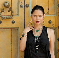 model wearing hand crafted green malachite necklaces earrings and rings