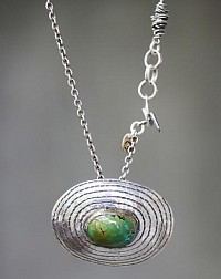 Silver pendant with bezel set green turquoise gemstone