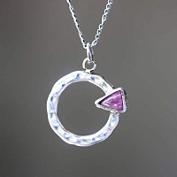 round silver pendant with free cut sapphire