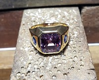 Alexandrite ring in gold band with side set gemstones